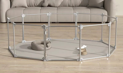Indoor pet playpen with pet bed, food bowl and toy on wooden floor in living room