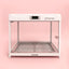 Modern transparent pet cabin with metal floor and white frame, front view on pink background